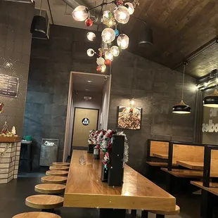 a wooden table and stools in a restaurant