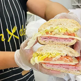 a person holding a sandwich