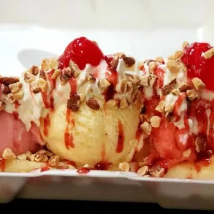 Banana split with,,, Strawberry,  Watermelon and Vanilla.  Chopped almonds,  whipped cream and raspberry drizzle.