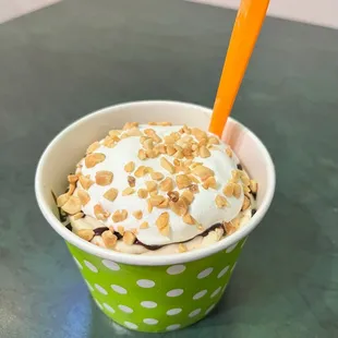 a cup of ice cream topped with nuts