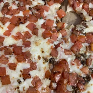 a pizza with tomatoes and cheese