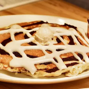 The Cinnamon Swirl Pancake is made with Cinnamon Slurry, Powdered Sugar Glaze &amp; Cinnamon Butter.