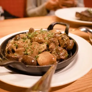 a skillet of mushrooms and potatoes