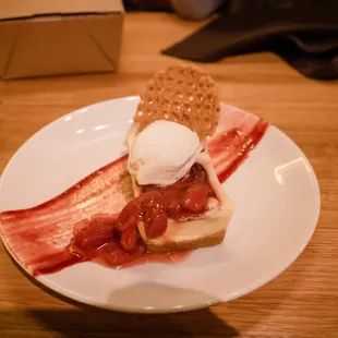 a plate of food with bacon and ice cream