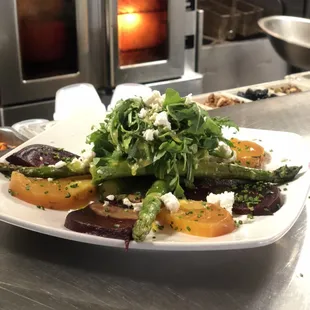 Roasted red and golden beets, rocket, grilled asparagus, Laura Chenel goat cheese and citrus vinaigrette on the side.