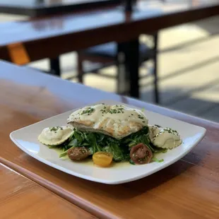 Fresh Catch of the Day - Pan roasted Alaskan Halibut served over house made wild mushroom ravioli, sautéed spinach &amp; lemon Beurre Blanc