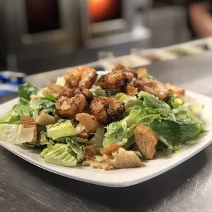 Blackened Shrimp Caesar Salad with Romaine Lettuce, jalapeños croutons, shaved parmesan &amp; Caesar dressing.