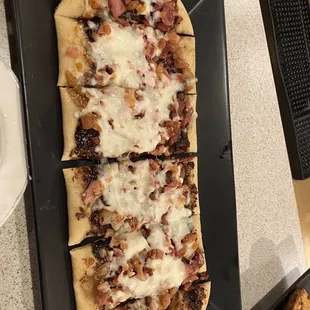 a flatbread pizza with meat and cheese