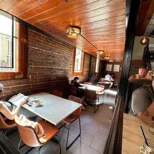 people sitting at tables in a restaurant