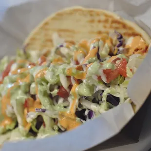 a taco filled with toppings