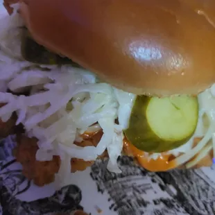 Chicken sandwich as it comes, with slaw,pickles, and sauce