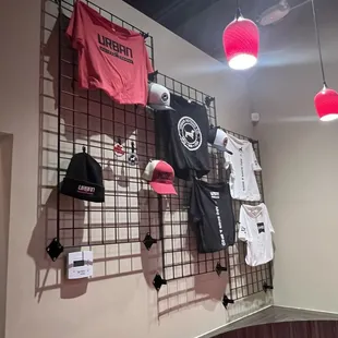 t - shirts hanging on a wall