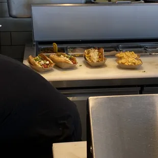 Behind the counter grilling