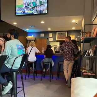 a group of people sitting at a bar