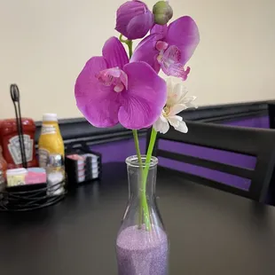 a vase of purple flowers