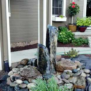 a water feature in a front yard