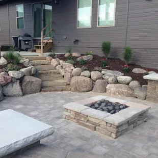 a patio with a fire pit