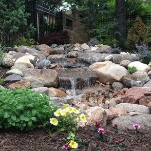 a small waterfall in a garden