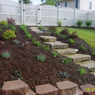 Have an awkward hillside?  Limestone steps and terraced retaining walls make a hard to mow hill into a beautiful garden...