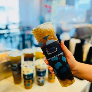 a hand holding a cold beverage