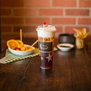 a cup of coffee and a bowl of fruit