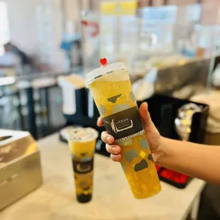 a person holding a cup of boba tea