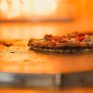 a pizza cooking in an oven