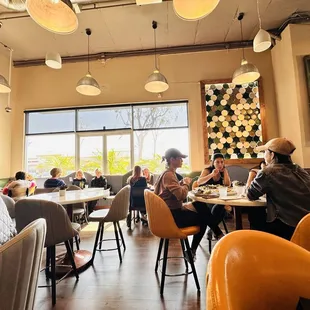 people sitting at tables in a restaurant
