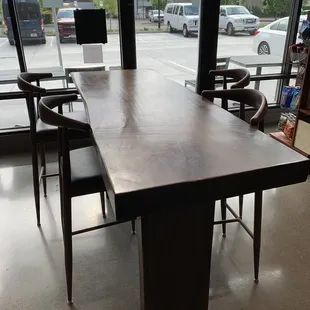 a table and chairs in front of a large window