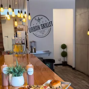 two trays of sandwiches on a wooden counter
