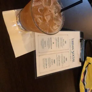 a drink and menu on a table