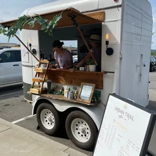 a man selling coffee from a food truck