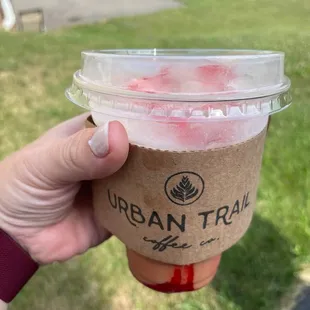 a hand holding a cup of coffee