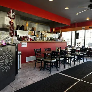 a dining area with tables and chairs