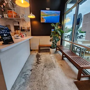 a wooden bench in front of a window