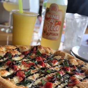 Margaritaville pizza, pineapple slushy and a bottle of wine
