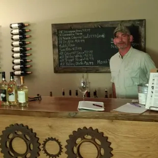 a man standing behind a bar