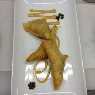 Crab and artichoke heart empanadas with grilled peach vinaigrette.