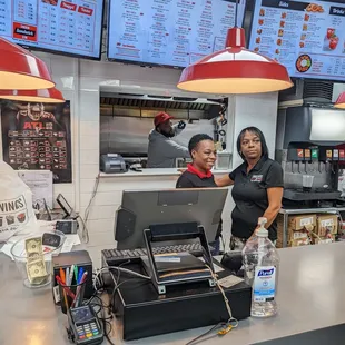 a man and a woman standing at a counter