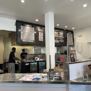 Manager and employee prepping our To-go order. Basamati Rice - GF, V Chicken &amp; Vegetable Potstickers Wings Boneless
