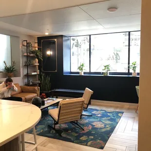 a woman sitting on a couch in a cafe