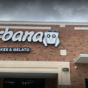a brick building with a sign that says urban bakery and gelato