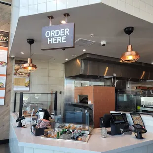 a counter with a order sign above it