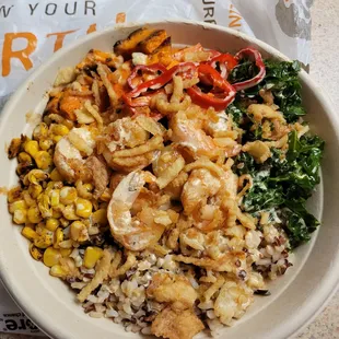 a bowl of rice, shrimp, and vegetables