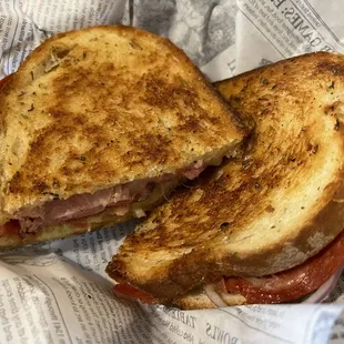 The Godfather. Mozzarella, ham, salami, pepperoni, tomatoes, red onions, and basil aioli served on butter herbed toasted. bread. A MUST