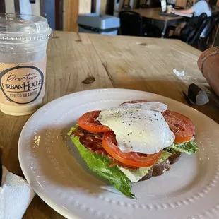 BLT avocado toast with fried egg over easy added