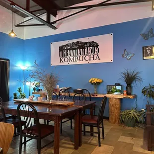 a dining room with blue walls and wood furniture