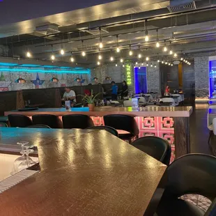 Dinning area, a lady is making home made tortillas.