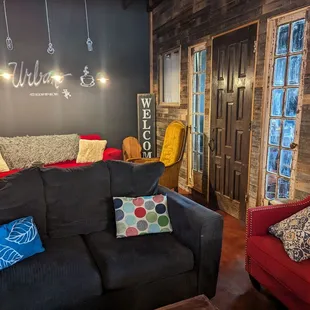 a black couch with colorful pillows