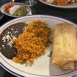 Chicken chimichanga with black beans and chicken chimichanga combo with a chicken enchilada.